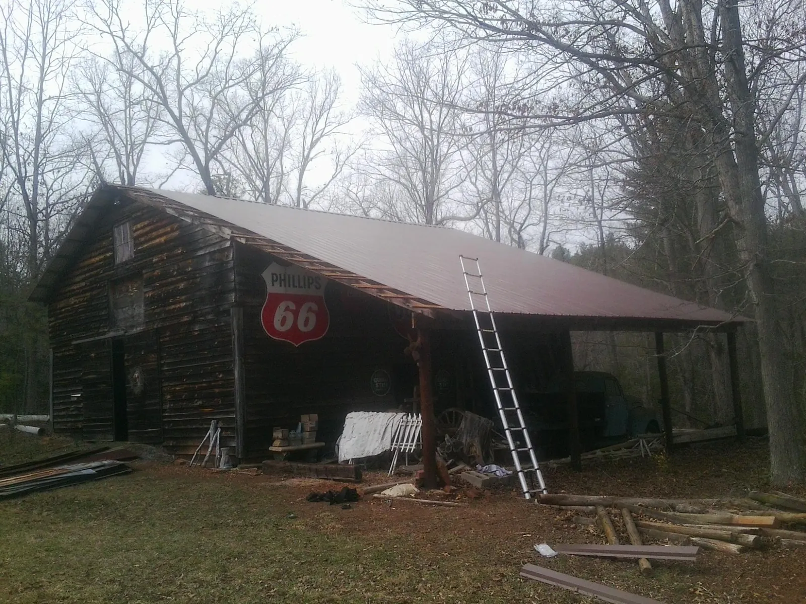 New metal roof on an open sided timber barn with a vintage sign in Albany